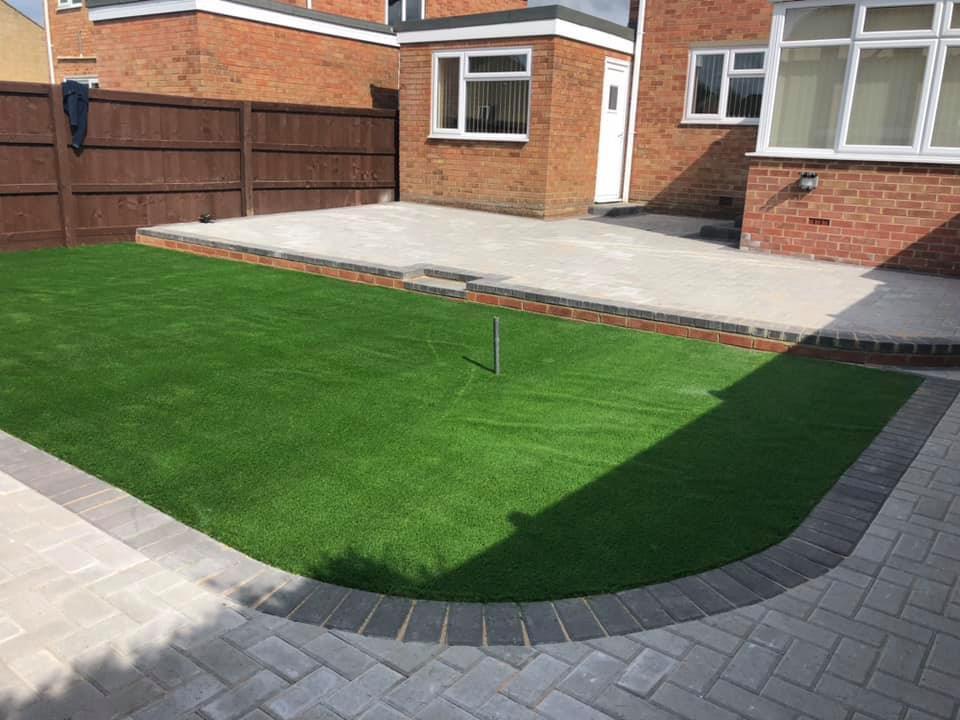 Completed front garden with artificial grass and light paving